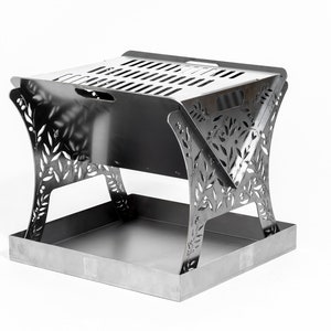 May include: A stainless steel portable fire pit with a square base and decorative leaf cutouts on the legs. The top has ventilation slots. The fire pit is designed for outdoor use and is shown against a white background.