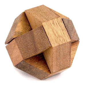 May include: A wooden puzzle in the shape of a cube with interlocking pieces. The puzzle is made of light brown wood with a natural grain.