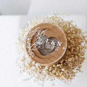 Rustic style oak ring bearer box with clear lid and personalized engraving, perfect for weddings.
