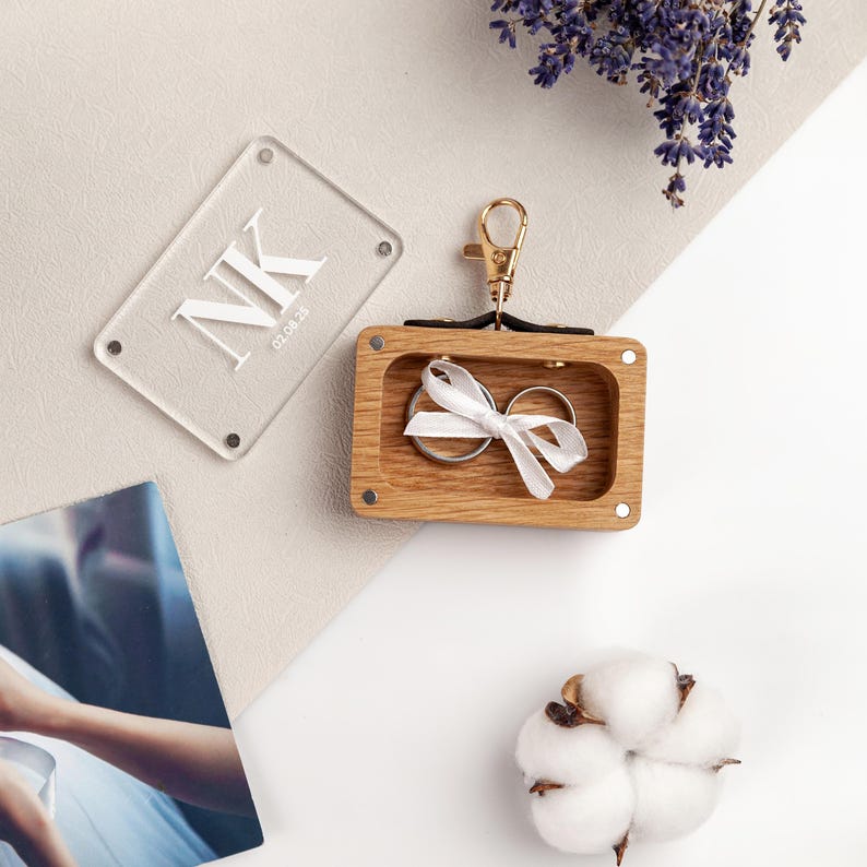 Dog collar accessory featuring engraved wooden ring holder.