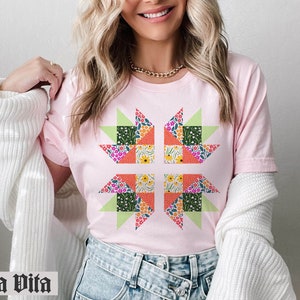 May include: A pink t-shirt with a floral patchwork design in the shape of a star. The shirt is made of a soft, comfortable fabric and has a relaxed fit.