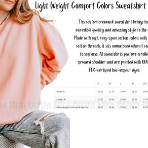 May include: A light pink crewneck sweatshirt with a rolled forward shoulder. The sweatshirt is made of soft, ring-spun cotton fabric with 100% cotton threads. The size chart shows the width, length, and sleeve length in inches for sizes S through 3XL.
