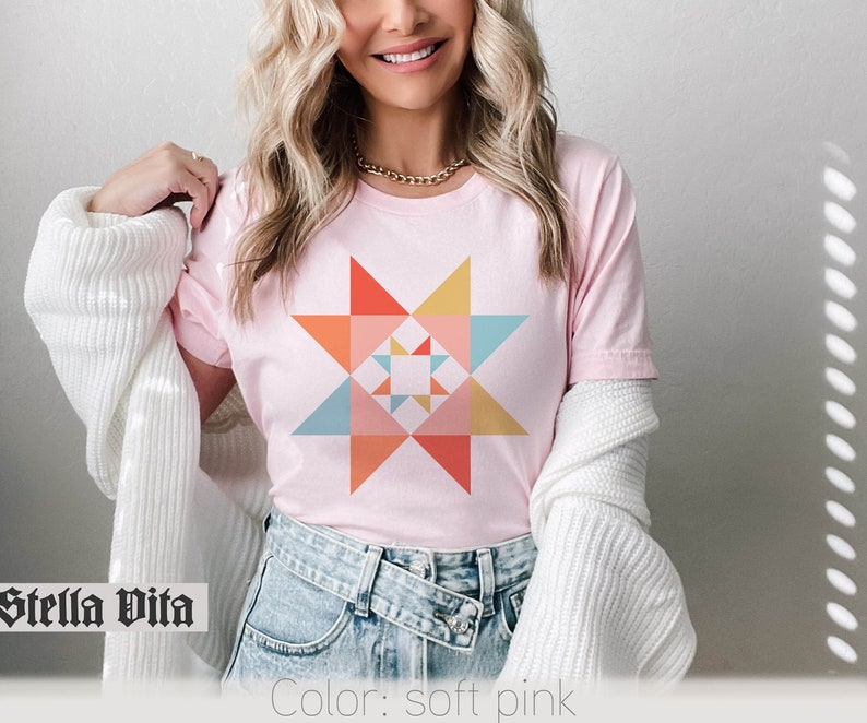 May include: A soft pink t-shirt with a colorful geometric star design. The text "Stella Vita" is visible at the bottom of the image.