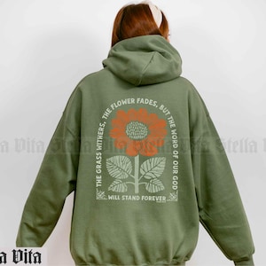 May include: Green hooded sweatshirt with a sunflower graphic and the text "The flower fades, but the word of our God will stand forever".