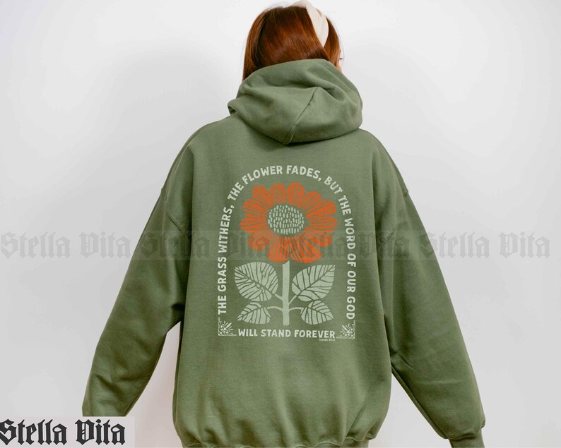 May include: Green hooded sweatshirt with a sunflower graphic and the text "The flower fades, but the word of our God will stand forever".