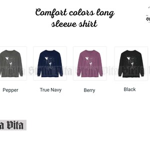 May include: Four long-sleeved shirts in different colors: pepper, true navy, berry, and black. Each shirt features a white graphic of a whale with stars on a dark background. The shirts are made of a soft, comfortable fabric.
