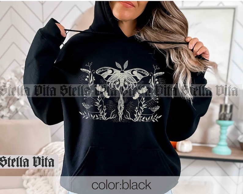 May include: Black hooded sweatshirt with a white graphic of a moth with wings spread and surrounded by flowers and vines. The text "color: black" is printed on the bottom of the sweatshirt.