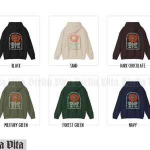May include: Hoodies in ten different colors featuring a sunflower graphic with the text "The Universe is Conspiring in Your Favor".