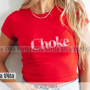 May include: A red cropped t-shirt with the word "Choke" printed in white on the front.