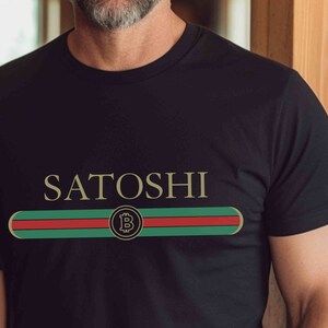 May include: Black t-shirt with a gold "SATOSHI" text and a green, red, and white stripe with a gold Bitcoin symbol.