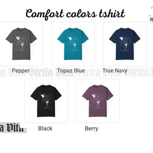 May include: Five t-shirts in different colors, each featuring a white graphic of an orca whale with geometric designs. The colors are pepper, topaz blue, true navy, black, and berry.