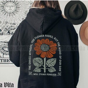 May include: Black hooded sweatshirt with a graphic print of a sunflower and the text "The grass withers, the flower fades, but the word of our God will stand forever".