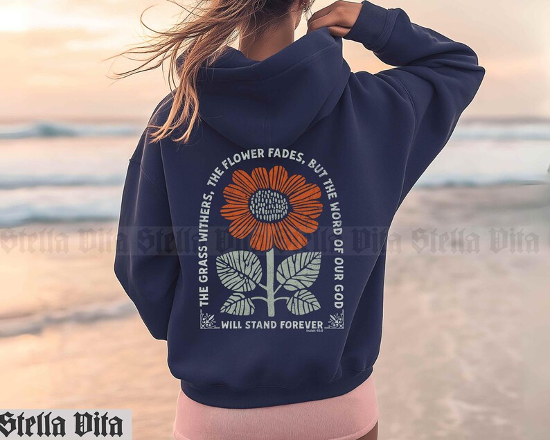 May include: Navy blue hooded sweatshirt with a graphic print of a sunflower and the text "THE GRASS WITHERS, THE FLOWER FADES, BUT THE WORD OF OUR GOD WILL STAND FOREVER."