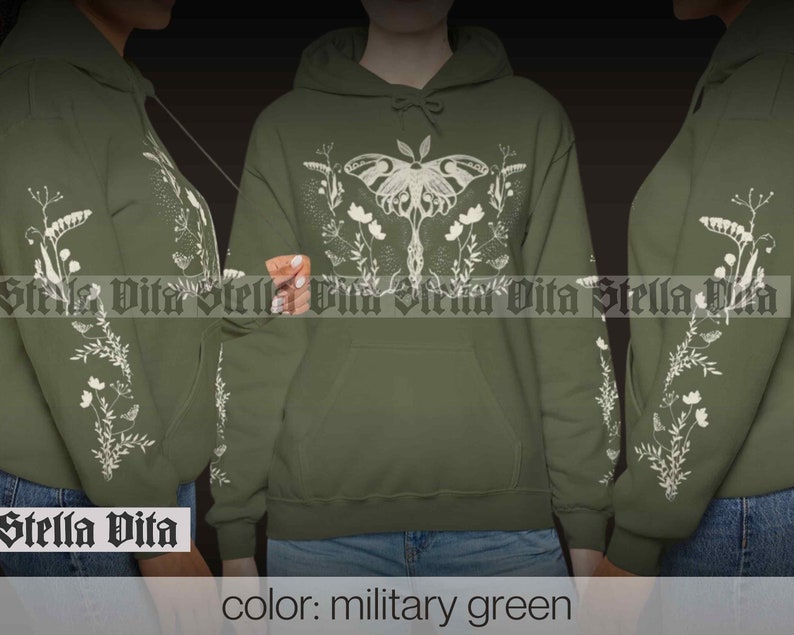 May include: A military green hoodie with a white print of a moth and floral design. The text "Stella Vita" is printed on the bottom left corner of the hoodie.