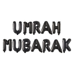 May include: Black balloon letters spelling "UMRAH MUBARAK" on a white background.