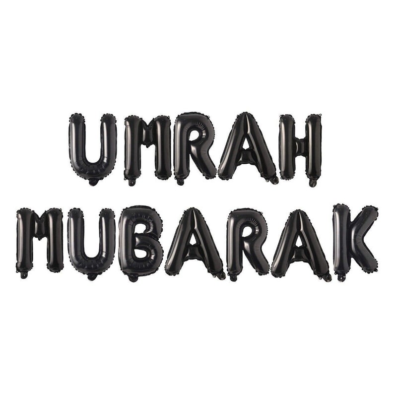 May include: Black balloon letters spelling "UMRAH MUBARAK" on a white background.