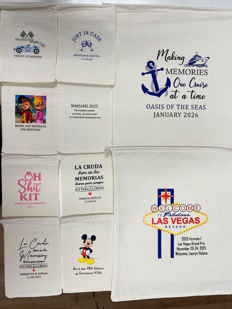 May include: A collection of ten off-white cotton drawstring bags of varying sizes, each featuring unique custom printed graphics and text for events like birthdays, cruises, and weddings, including themes like Las Vegas, Mickey Mouse, and nautical designs.
