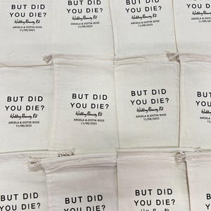 May include: A collection of off-white cotton drawstring bags featuring black printed text that reads BUT DID YOU DIE? Wedding Recovery Kit, followed by the names Angela & Justin Huse and the date 11/08/2025, arranged in a grid pattern.
