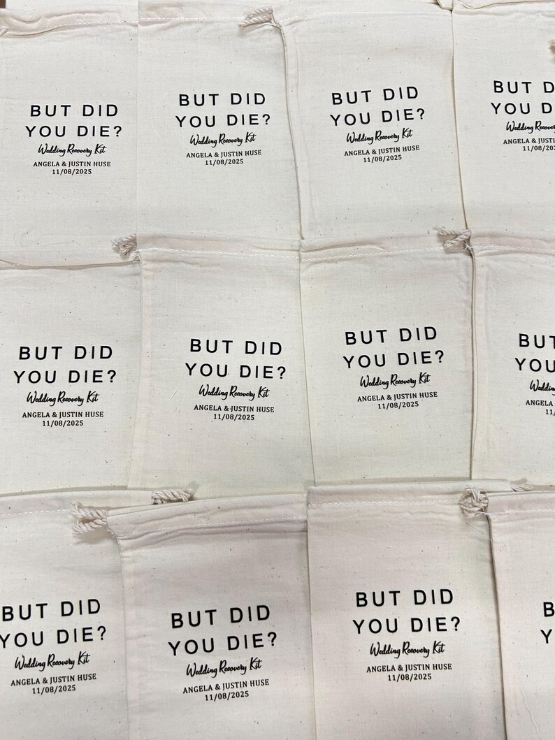 May include: A collection of off-white cotton drawstring bags featuring black printed text that reads BUT DID YOU DIE? Wedding Recovery Kit, followed by the names Angela & Justin Huse and the date 11/08/2025, arranged in a grid pattern.