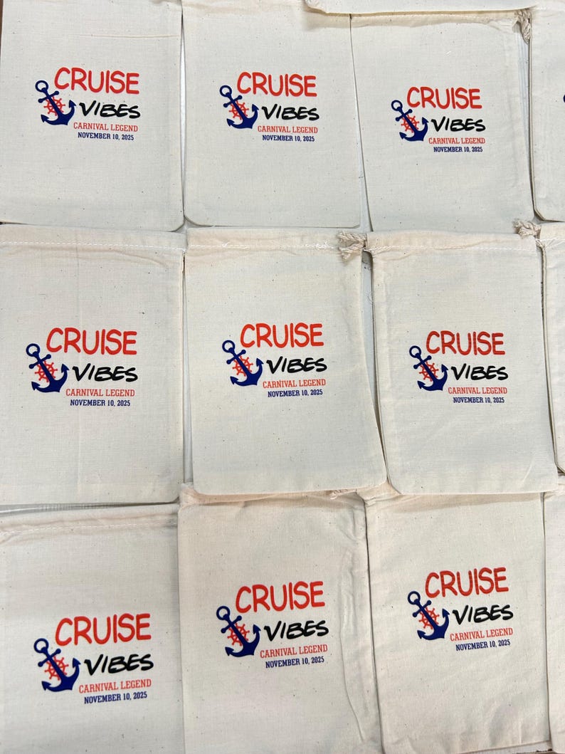 May include: A collection of off-white cotton drawstring pouches, each featuring a printed design with a blue anchor, a red ship's wheel, and the text CRUISE VIBES, CARNIVAL LEGEND, NOVEMBER 10, 2025, arranged in a grid pattern on a flat surface.