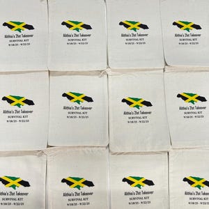 May include: A collection of twelve off-white cotton drawstring bags, each printed with a green, yellow, and black map of Jamaica. Below the map, the text reads Alithia's 21st Takeover, SURVIVAL KIT, and the date range 9/18/25 - 9/22/25.