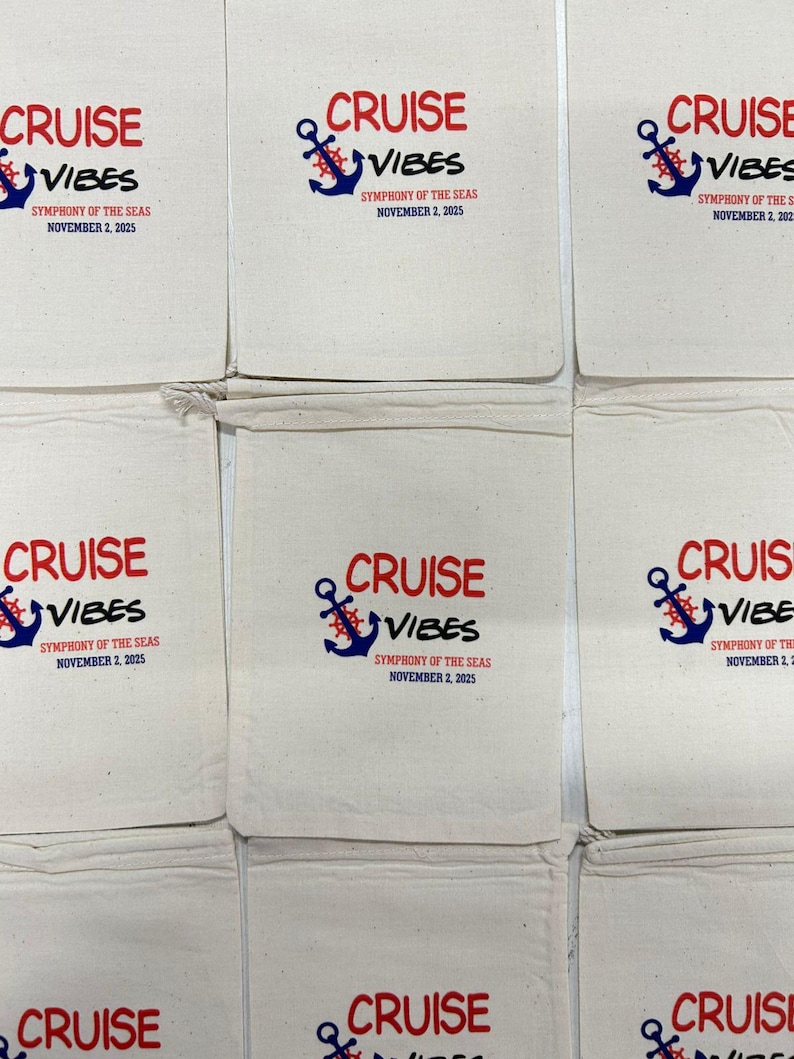 May include: A collection of off-white cotton drawstring bags featuring a printed design with a blue anchor, a red ship wheel, and the text CRUISE VIBES, SYMPHONY OF THE SEAS, and NOVEMBER 2, 2025, arranged in a grid pattern on a flat surface.