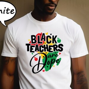May include: White t-shirt with a black graphic that says "Black Teachers are Dope" with a green, yellow, and red outline of Africa.