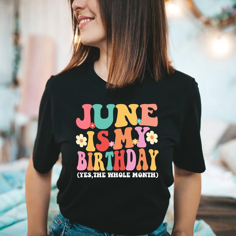 May include: Black t-shirt with a colorful graphic that says "June is my birthday (yes, the whole month)".
