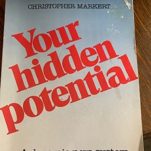 May include: A book cover with the title "Your hidden potential" in red text. The subtitle is "A dynamic new system for discovering the power within you." The author's name, Christopher Markert, is printed at the top of the cover.