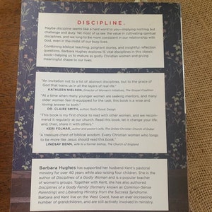 May include: Book cover with a blue background and white flowers. The title of the book is "Discipline" in red letters. The author is Barbara Hughes. The book is about spiritual disciplines for women.