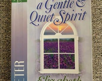 May include: Book cover with a lavender field scene and the title "Putting On a Gentle & Quiet Spirit" by Elizabeth George. The book is part of the "A Woman After God's Own Heart" series.