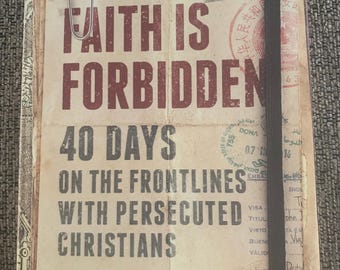 May include: A book titled "When Faith Is Forbidden: 40 Days on the Frontlines with Persecuted Christians" by Todd Nettleton. The book cover features a worn, vintage aesthetic with stamps and markings, suggesting a journey through various countries. The book is published by The Voice of the Martyrs.