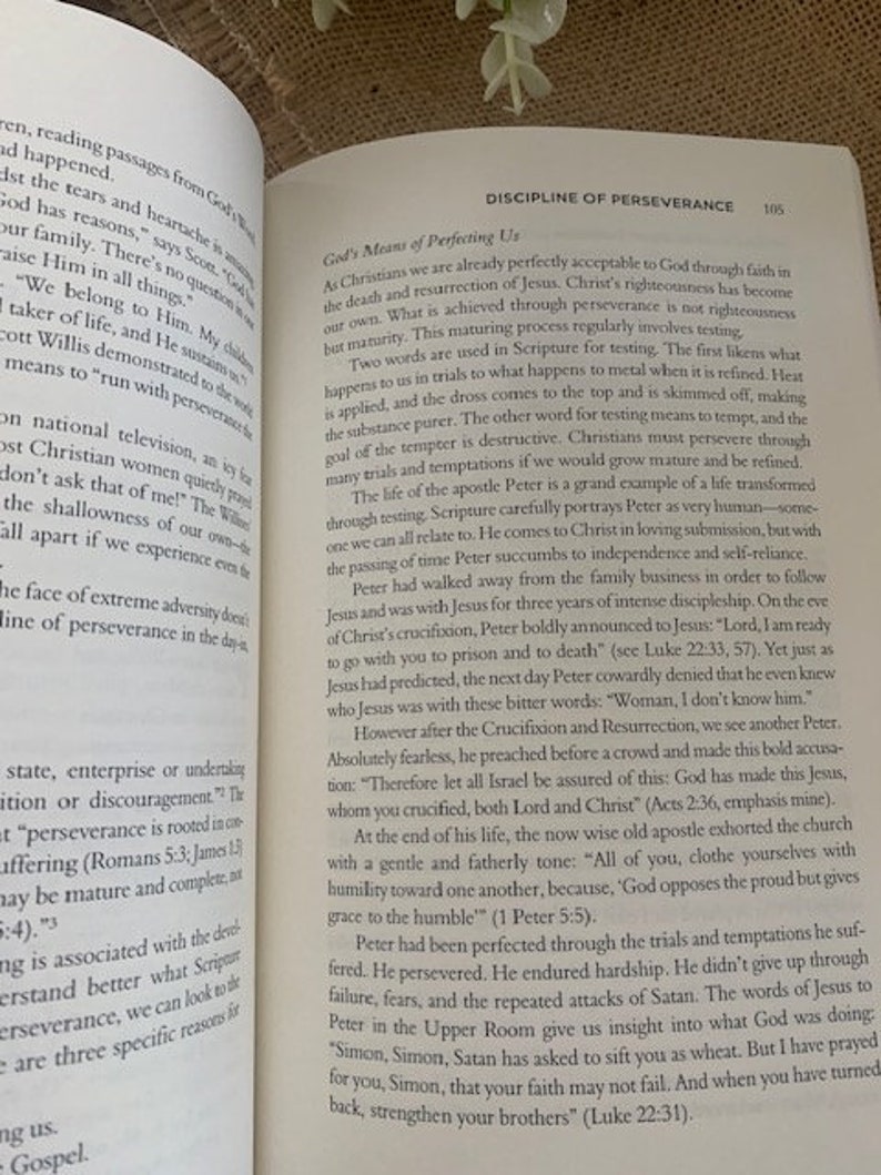 May include: Open book with a white background. The book is open to a page titled "Discipline of Perseverance" with text about the importance of perseverance in the Christian faith. The text includes quotes from the Bible and examples of how to persevere through trials and temptations.