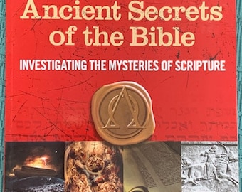 May include: A red magazine cover with the title "Ancient Secrets of the Bible" and the subtitle "Investigating the Mysteries of Scripture". The cover features a gold seal with a symbol and a variety of images including a boat, a scroll, and a stone carving.