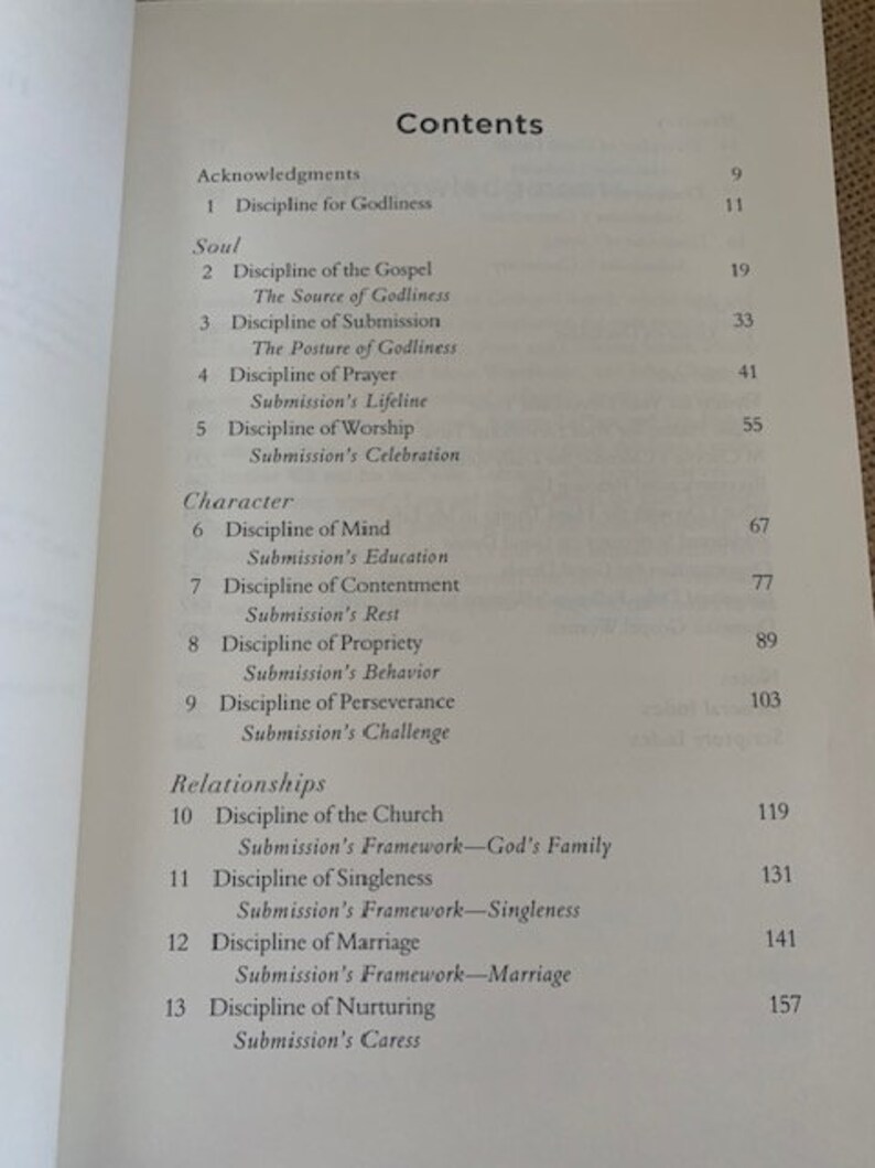May include: A book titled "Contents" with a table of contents listing chapters and page numbers. The chapters are organized into three sections: "Acknowledgments", "Soul", and "Character".