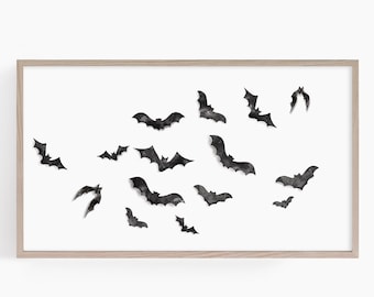 May include: A framed print featuring a flock of watercolor bats in various sizes and poses. The bats are rendered in shades of gray and black against a white background. The artwork is enclosed in a light-colored wooden frame, suitable for Halloween decor.