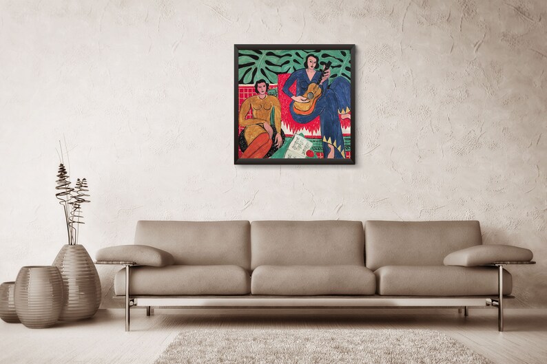 May include: A framed painting depicting two women, one playing a guitar, the other seated with a book. The painting is set against a backdrop of green leaves and a red and white patterned rug.