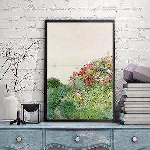 May include: A framed watercolor painting depicting a lush garden with a path leading to a distant coastline. The garden is filled with vibrant pink, red, and white flowers, surrounded by green foliage. The painting has a soft, dreamy aesthetic.
