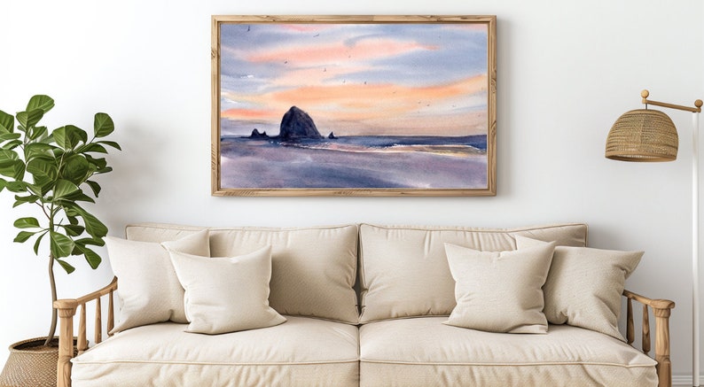 Puede incluir: Una pintura de acuarela de una costa rocosa con un cielo de puesta de sol. La pintura presenta una gran formaci&oacute;n rocosa en el centro, con rocas m&aacute;s peque&ntilde;as y una playa en primer plano. El cielo es una mezcla de rosa, naranja y azul, con algunas aves volando por encima.
