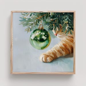 May include: An oil painting featuring a ginger cat paw reaching towards a shiny green Christmas ornament hanging from a pine branch. The artwork captures the texture of the cat's orange fur, the reflective surface of the bauble, and pine needles.