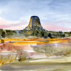 May include: A watercolour painting depicting a large, dark grey rock formation rising from a grassy field. The sky is a pale blue with hints of pink and orange. There are a few small birds flying in the sky.