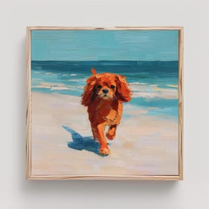 May include: An oil painting in a light wood frame depicting a reddish-brown Cavalier King Charles Spaniel running on a sandy beach. The background features a bright blue ocean and sky, rendered with visible, textured brushstrokes throughout.