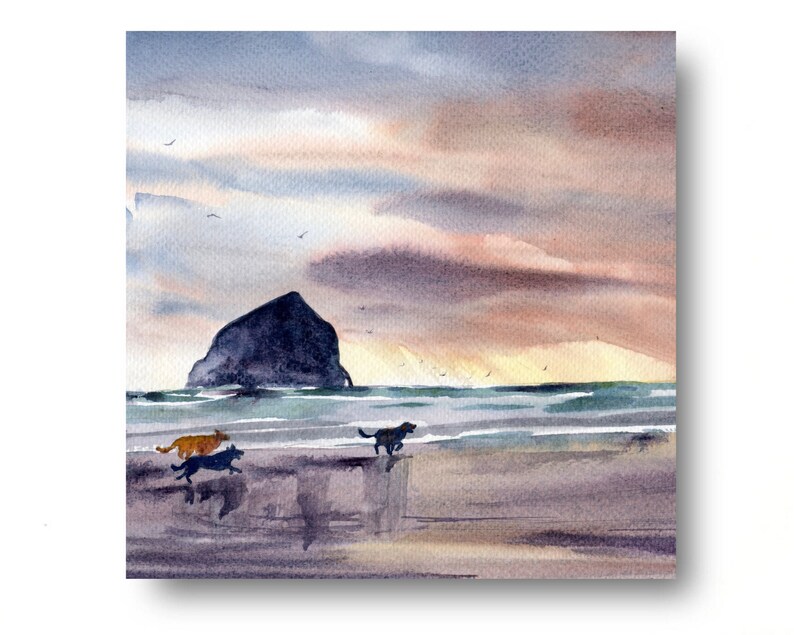 May include: Watercolor painting of a beach scene with a large rock formation in the distance and three dogs running on the sand. The sky is a soft pink and orange with clouds.