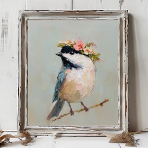 May include: An oil painting of a chickadee wearing a floral crown of pink and white blossoms, perched on a thin branch. The bird features black, white, and blue-grey plumage with visible impasto brushstrokes, set within a distressed white frame.