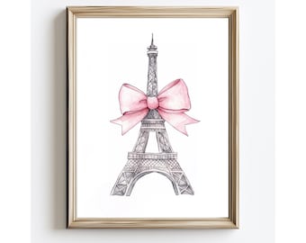 May include: A framed wall art print featuring a black and white ink sketch of the Eiffel Tower adorned with a large, soft pink watercolor bow tied around its midsection. The artwork is encased in a simple, light-toned wooden frame.