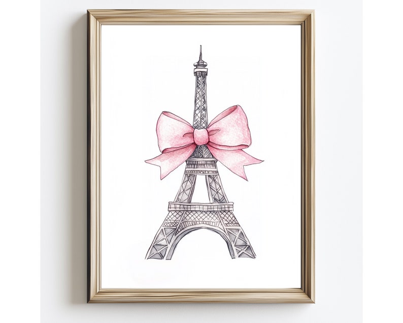 May include: A framed wall art print featuring a black and white ink sketch of the Eiffel Tower adorned with a large, soft pink watercolor bow tied around its midsection. The artwork is encased in a simple, light-toned wooden frame.