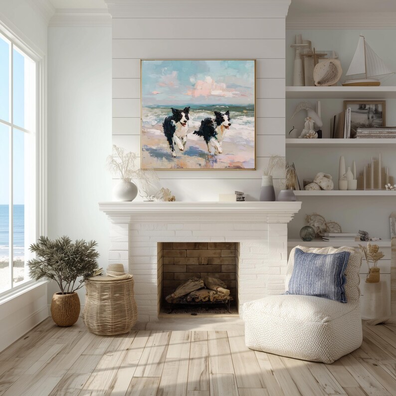 May include: A square wall art print featuring an oil painting of two black and white Border Collie dogs running along a sandy beach with ocean waves in the background under a soft pink and blue sky, framed in a thin gold metal frame.