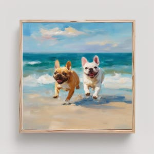 May include: A square framed oil painting depicting two French bulldogs, one fawn and one white, running through shallow ocean waves on a sandy beach under a bright blue sky with soft clouds. The artwork is enclosed in a light-toned wooden frame.