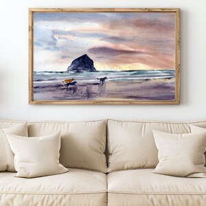 May include: A watercolor painting of a beach scene with a rocky island in the distance. The sky is a soft pink and orange, and the water is a light blue. Three dogs are running on the beach.