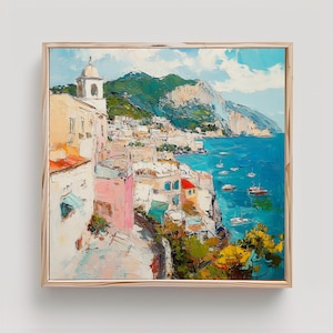 May include: Oil painting of a coastal town with colorful buildings, boats, and a mountain backdrop. The artwork features a bright blue sea and sky, with a wooden frame. The buildings are painted in shades of pink, yellow, and white.